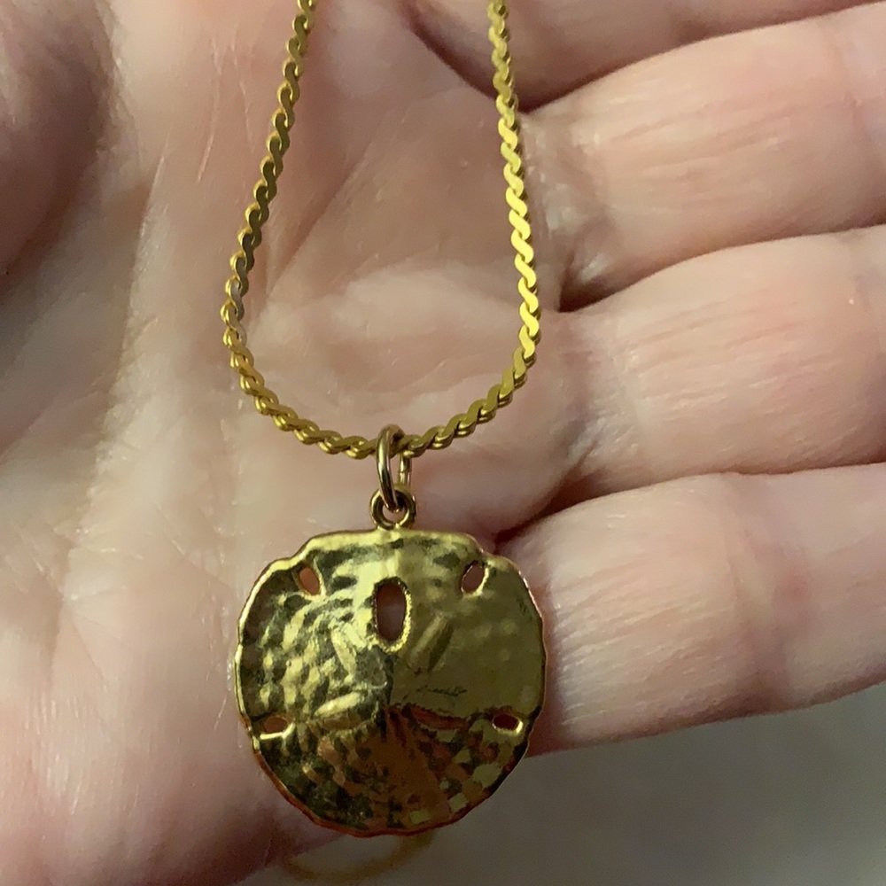 Women’s gold tone sand dollar necklace, measures 8 inches in length, Pendent Is